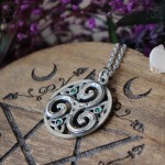Triskel pendant in a circle, adorned with triquetra and small crystals, celtic and irish jewelry
