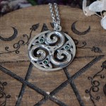 Triskel pendant in a circle, adorned with triquetra and small crystals, celtic and irish jewelry
