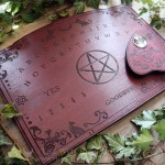 Ouija board adorned with cats, a pentagram and victorian ornaments, made from burgundy wood
