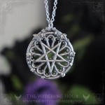 Gothic pentagram necklace on a cathedral rose window, occult jewelry