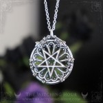 Gothic pentagram necklace on a cathedral rose window, occult jewelry