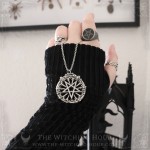 Gothic pentagram necklace on a cathedral rose window, occult jewelry