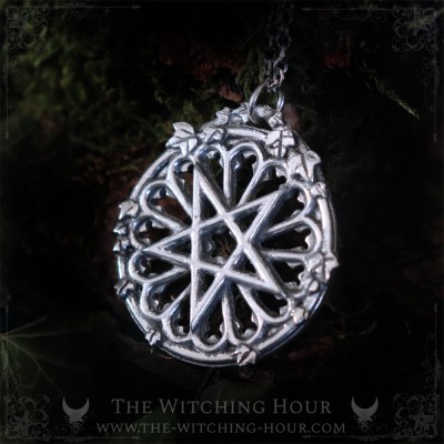 Gothic pentagram necklace on a cathedral rose window, occult jewelry