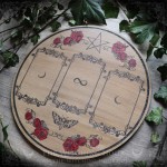 Wooden divination board decorated with red roses and a pentacle, for three-card tarot or oracle readings.