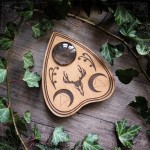 Wooden Ouija planchette decorated with a deer skull and crescent moons, curiosity cabinet decoration