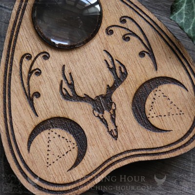 Wooden Ouija planchette decorated with a deer skull and crescent moons, curiosity cabinet decoration