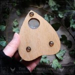 Wooden Ouija planchette decorated with a deer skull and crescent moons, curiosity cabinet decoration