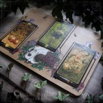 Tarot spread board with a cat skull surrounded by flowers and Ivy leaves, engraved wood