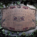Wooden ouija board adorned with a pentagram in a triple moon, talking board and planchette, for spiritualism