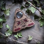 Wooden ouija board adorned with a pentagram in a triple moon, talking board and planchette, for spiritualism