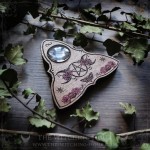 Wooden ouija board adorned with a pentagram in a triple moon, talking board and planchette, for spiritualism