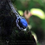 Blue labradorite necklace surrounded by leaves, nature inspired handmade jewelry