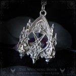 Sigil of Lucifer necklace in a gothic cathedral surrounded by two gargoyles
