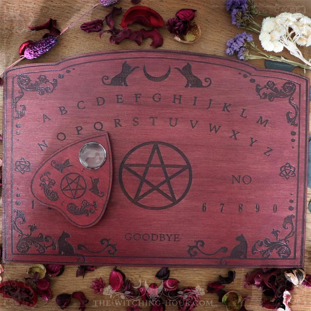 Red wooden ouija board with cats