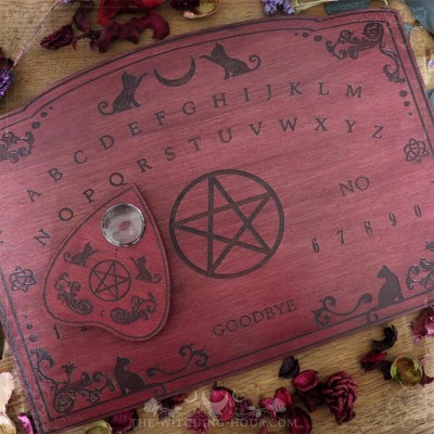 Red wooden ouija board with cats