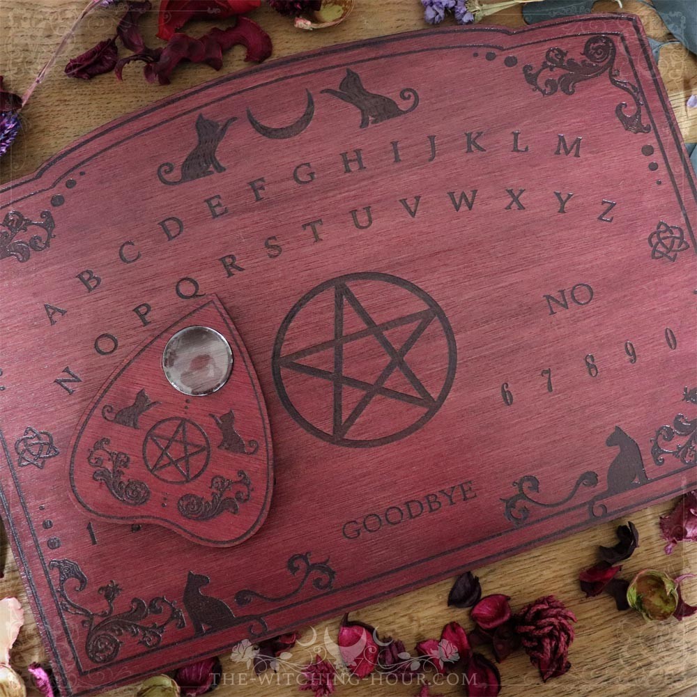 Red wooden ouija board with cats