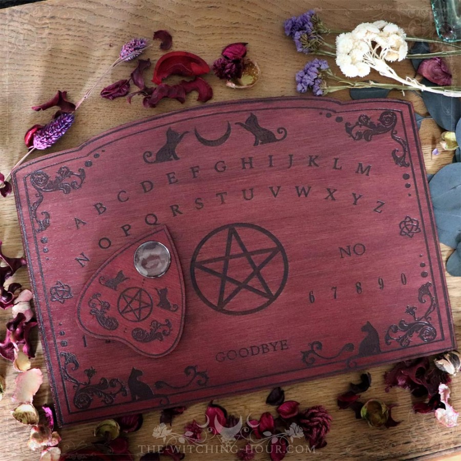 Red wooden ouija board with cats