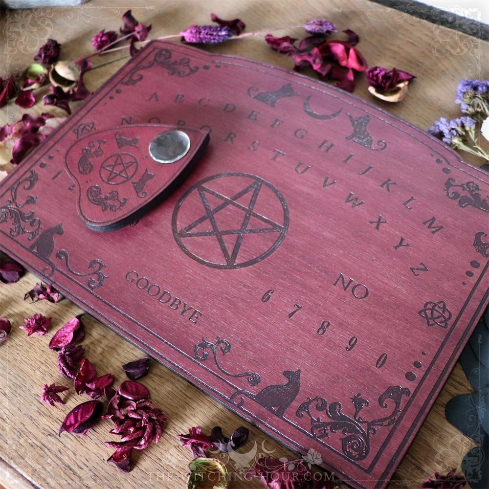 Red wooden ouija board with cats