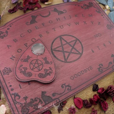 Red wooden ouija board with cats