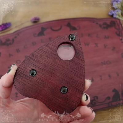 Red wooden ouija board with cats