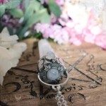 Pendant with large quartz point and natural rainbow moonstone
